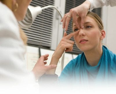 Otolaryngologist examining patient's nose