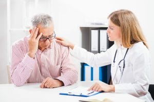 Doctor counsels a worried elderly patient
