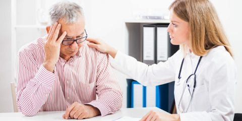 Doctor counsels a worried elderly patient