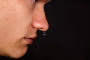 clear dripping from nose