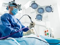 Surgeon removing brain tumors using minimally invasive EEA technique.