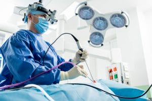 Surgeon removing brain tumors using minimally invasive EEA technique.