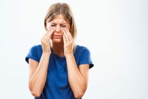 woman with facial pain from sinusitis complication
