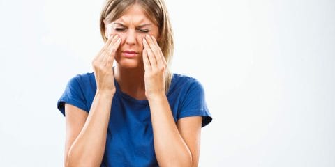 woman with facial pain from sinusitis complication